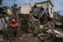 Death toll from torrential rains in Mexico rises to 64 as search expands
